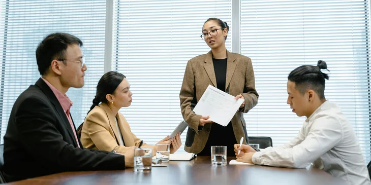 A quality manager presenting statistical reports to the team.
