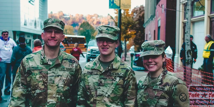 Three soldiers standing in the middle of the street.