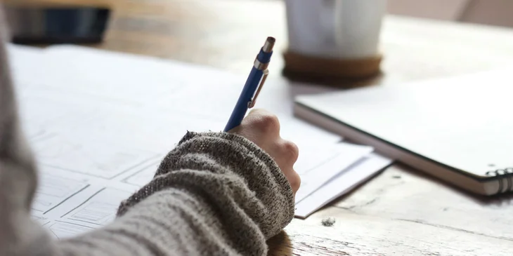 A person writing a reference letter.