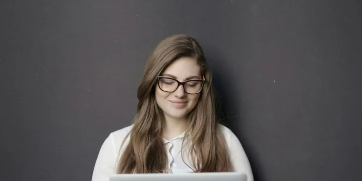 A woman working on her laptop.