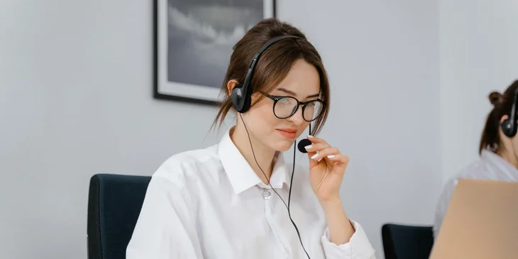 A female reservation agent handling customer reservations.