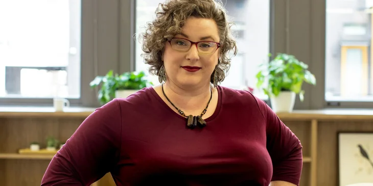 A woman at work in bright, open office workplace.