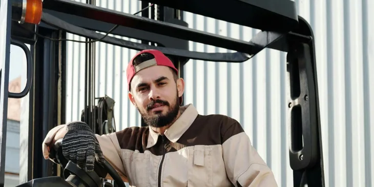 An industrial worker operating a forklift.