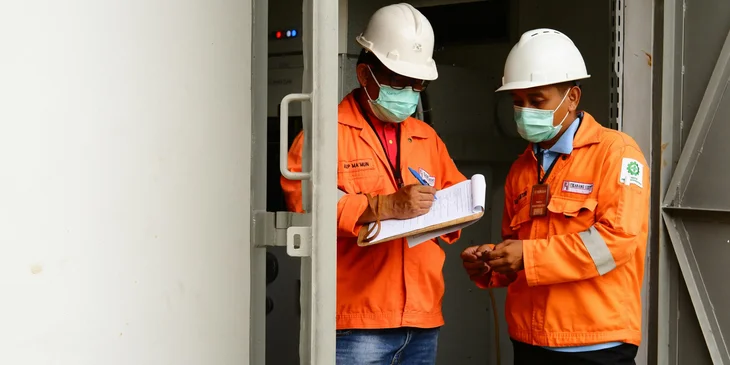 A safety director signing a document to certify that the building is safe.