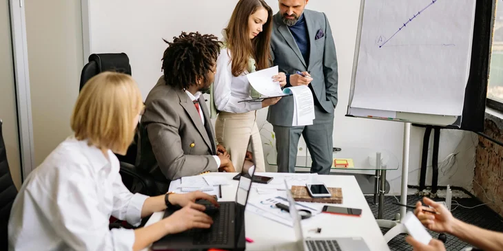 A sales and marketing executive conducting a meeting on market research about competitors' products.