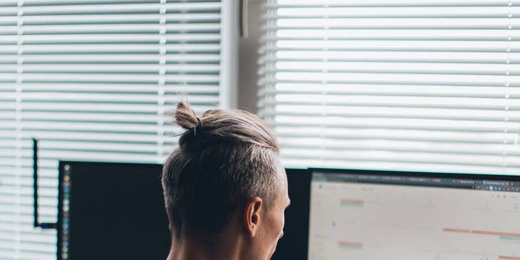 Salesforce developer designing a new application on his desktop computer.