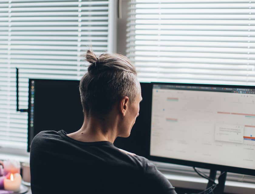 Salesforce developer designing a new application on his desktop computer.