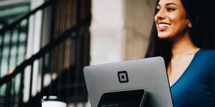 A woman working in front of a laptop.