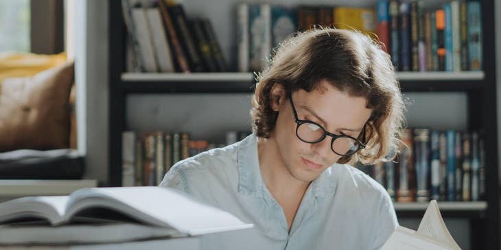Man reading an writing in a book