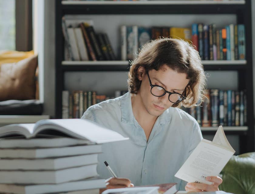 Man reading an writing in a book