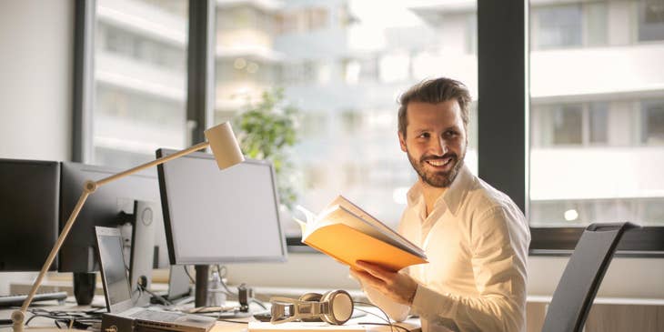 Financial analyst at a desk holding documents