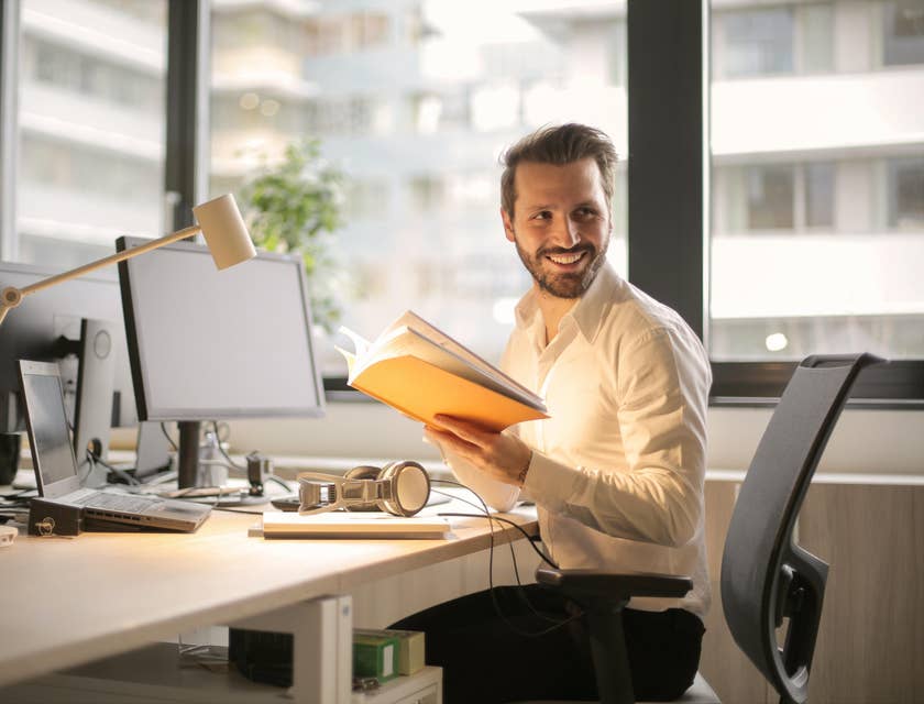 Financial analyst at a desk holding documents