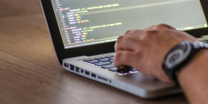 A senior software developer adjusting the website's content and media.