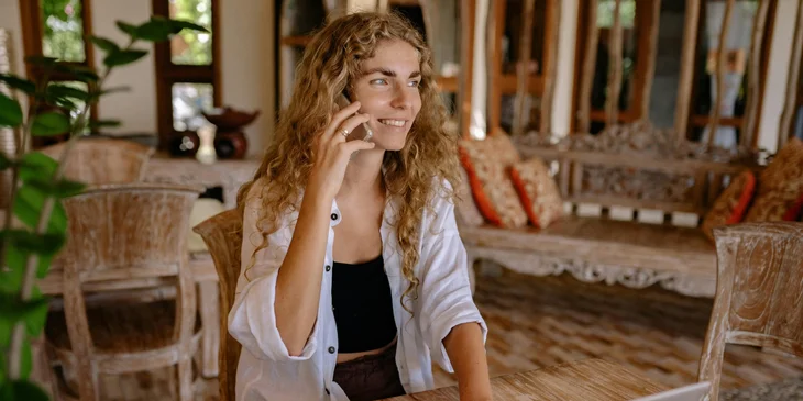 A woman talking on the phone while working.