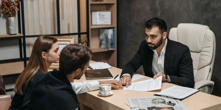 A legal counsel explaining the contract to clients.
