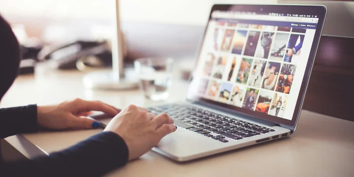 A social media manager working on a laptop.