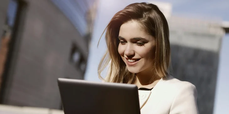 A social media strategist looking at her online content on a tablet.