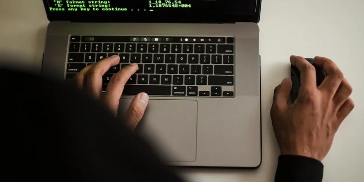 A software engineer coding on a laptop.