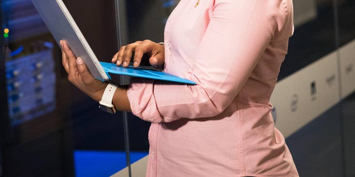 A software engineer holding a laptop.