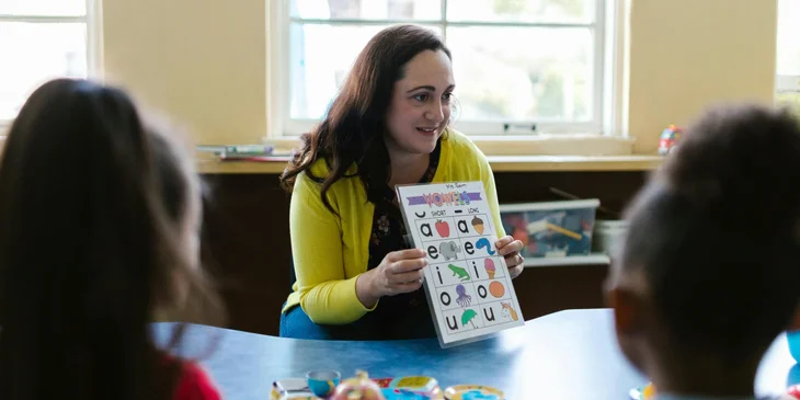 A speech therapist teaching letter sounds.