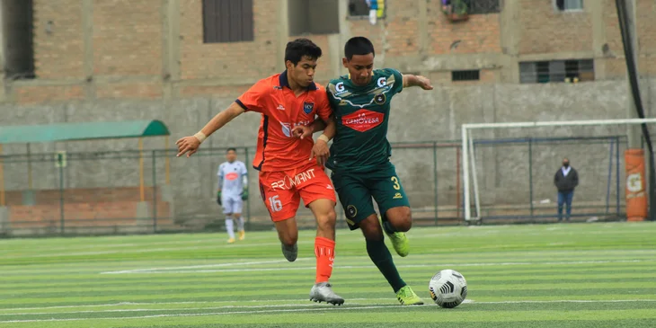Two soccer players in action during a game.