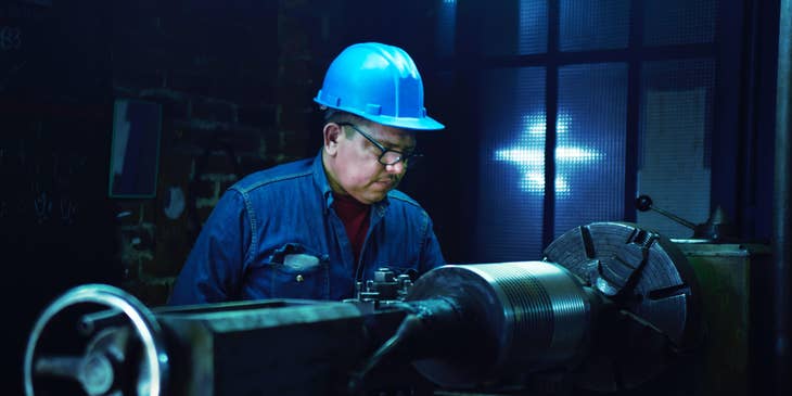 A steamfitter inspecting machinery on a construction site.