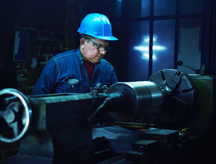 A steamfitter inspecting machinery on a construction site.