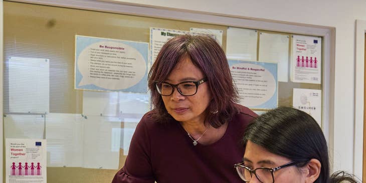 Student counselor reviews evaluation scores to help achieve academic goals