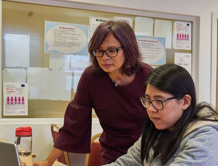 Student counselor reviews evaluation scores to help achieve academic goals