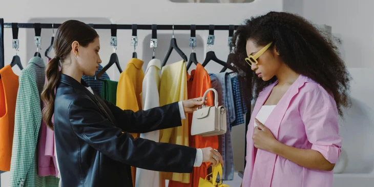A stylist gives the client suggestions and advice on which accessories to use that match her outfit.