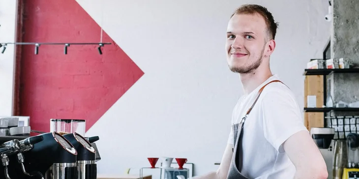 A barista in a white crew neck shirt.