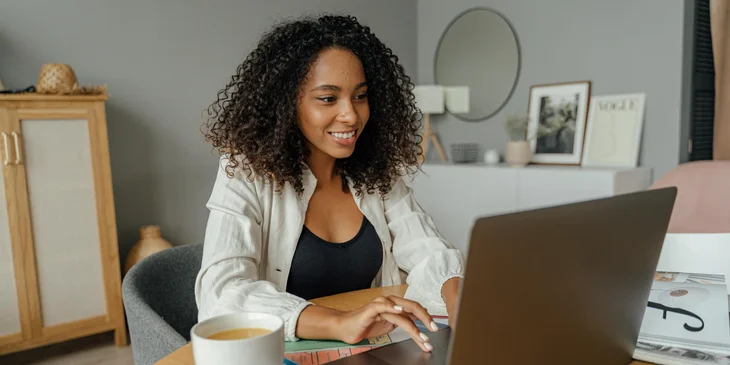 A woman working on her laptop.