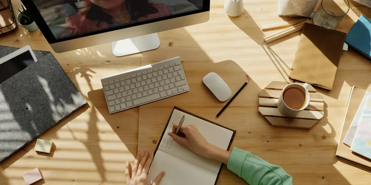 A woman working from home attends an online meeting with her supervisor.