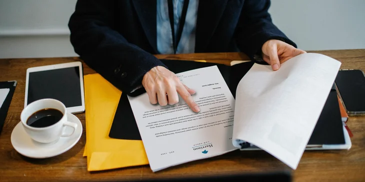 An HR representative reviewing the temporary layoff letter for the employee.