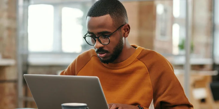 A man working on a laptop.