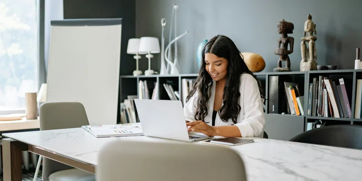 A woman composing a thank-you email after a phone interview.