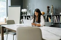 A woman composing a thank-you email after a phone interview.