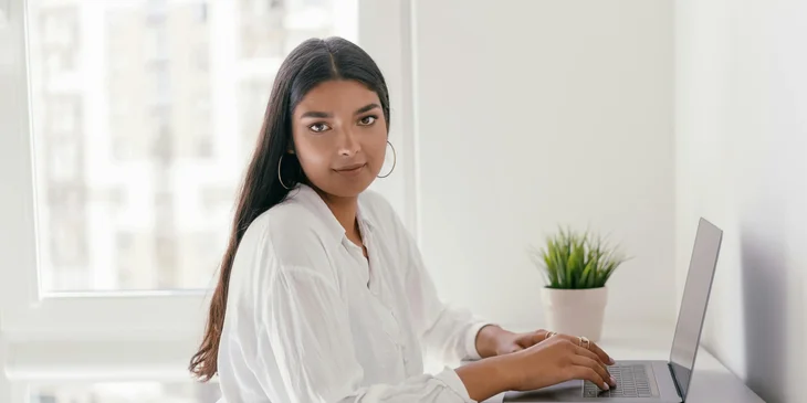 A woman browsing on a laptop.