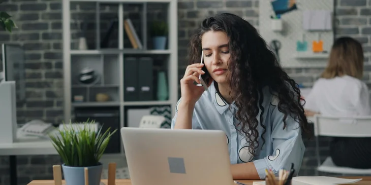 A woman using a laptop.