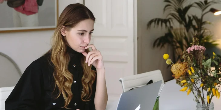 A woman using a laptop.