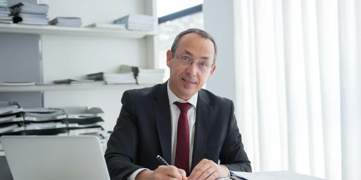 A man writing notes at his desk.