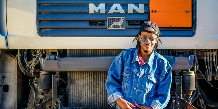 A man standing in front of a truck.