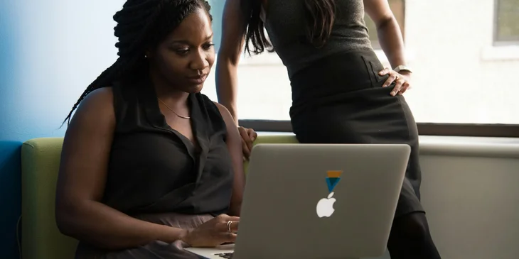 A woman sitting in front of a laptop.