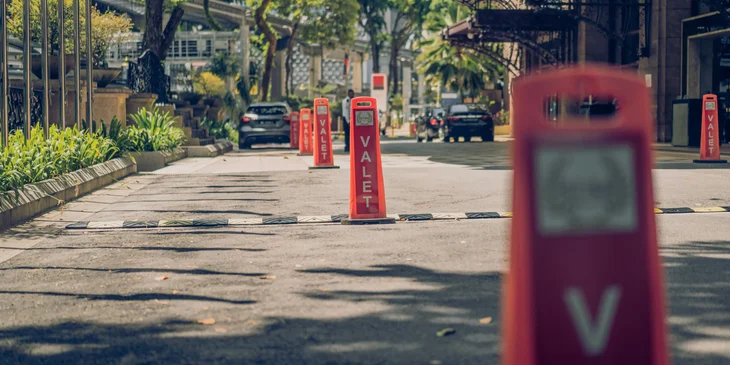 A road with signs that say 'VALET'.