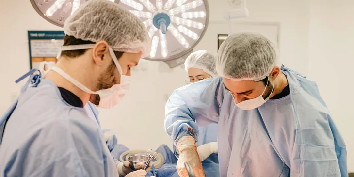 A vascular surgeon performs surgery to repair a patient's injured blood vessels.