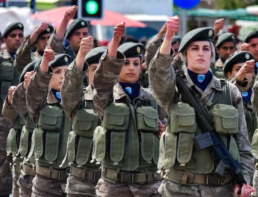 Veterans raising their fists at a parade.