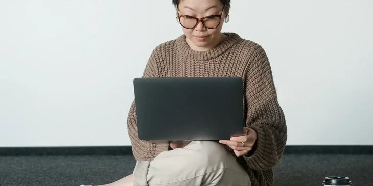 A woman working on her laptop.