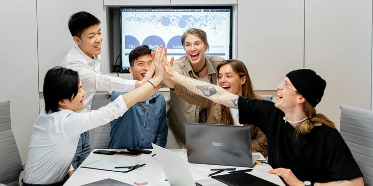 A group of coworkers high-fiving.