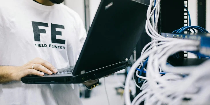A VoIP network engineer troubleshooting the VoIP system that he installed for a tech company.