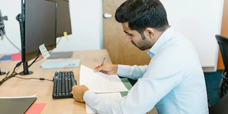 An employee reviewing a letter for voluntary layoff.